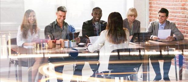A woman being interviewed by a panel