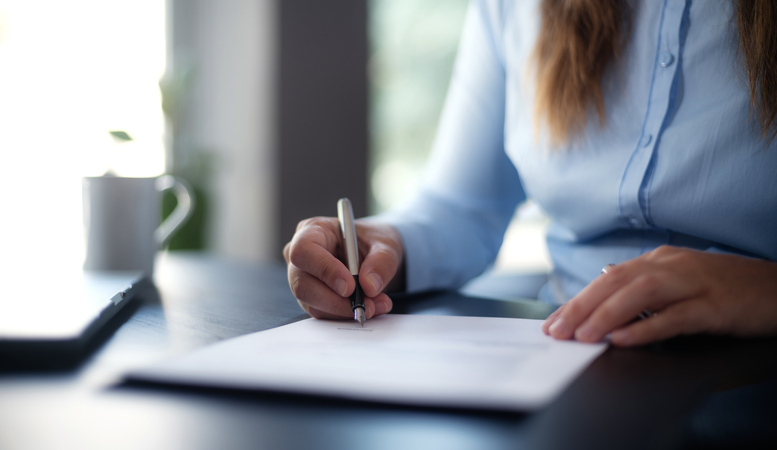 businesswoman signing an official document